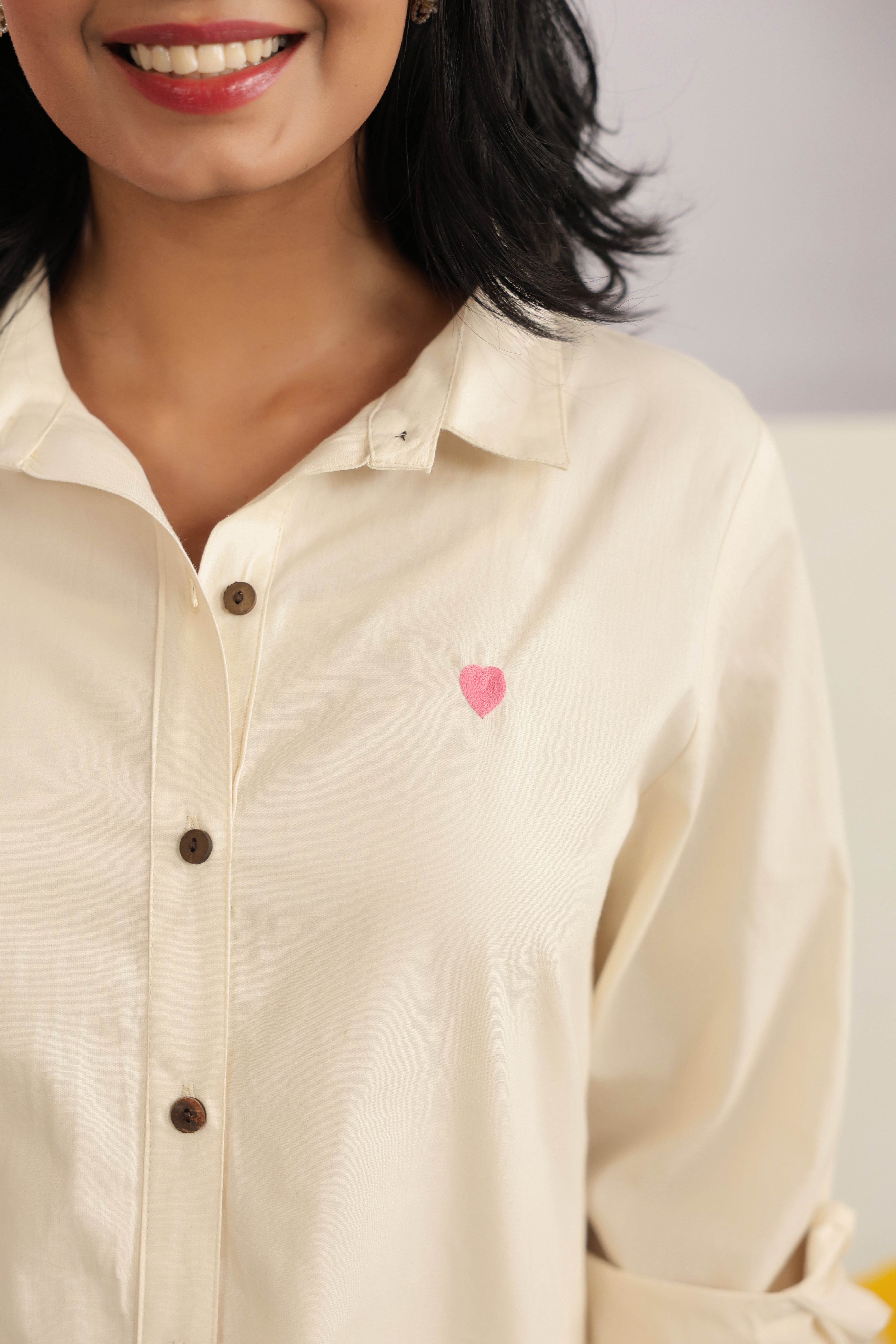 Woman wearing an ivory cotton shirt and shorts co-ord set featuring a classic collared button-down shirt with full sleeves and matching relaxed-fit shorts, creating a minimalist and elegant look ideal for casual outings, vacations, resort wear, and everyday summer styling.