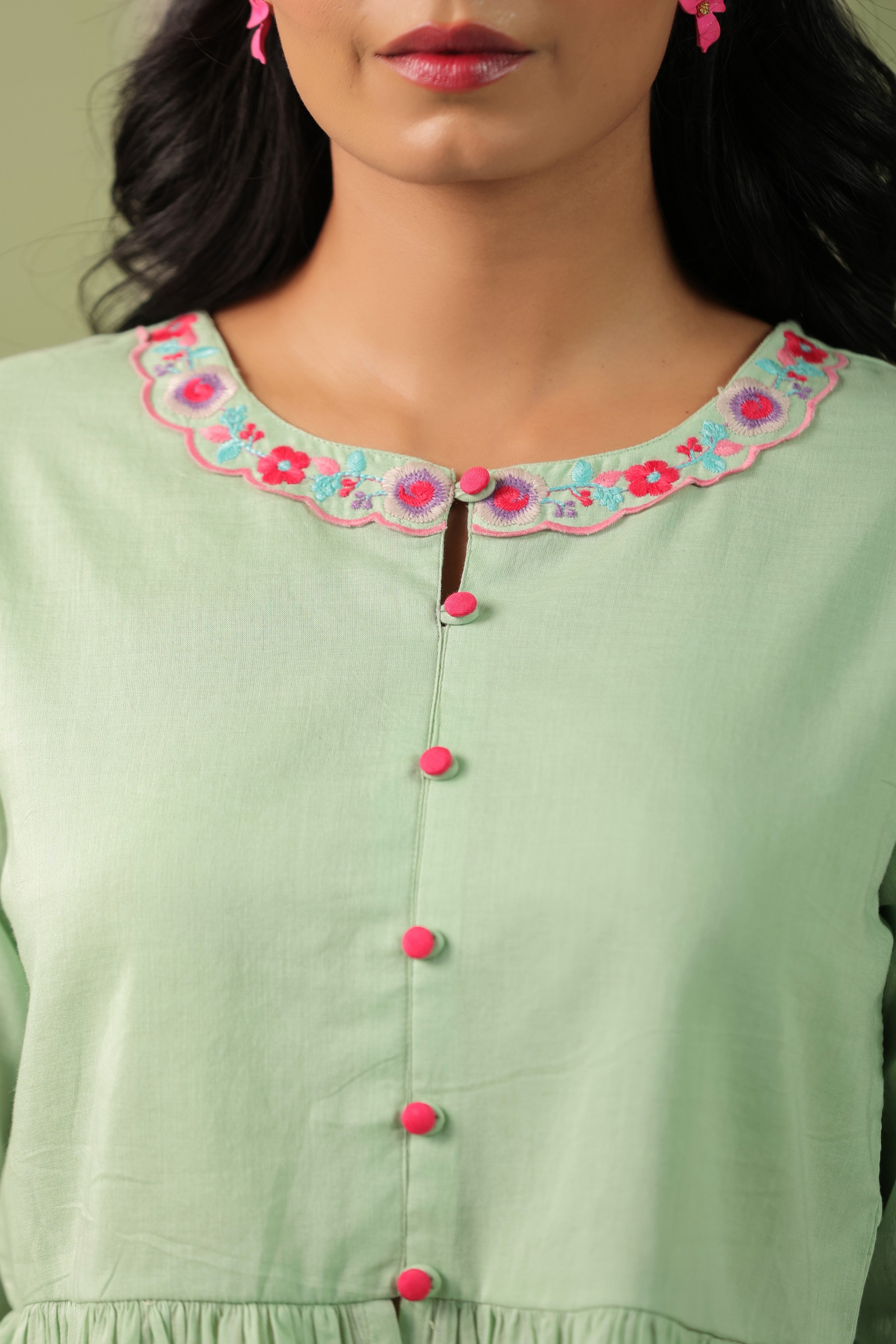 Woman wearing a pista green embroidered peplum co-ord set with wide-leg palazzo pants, round embroidered neckline, and floral detailing for ethnic casual wear