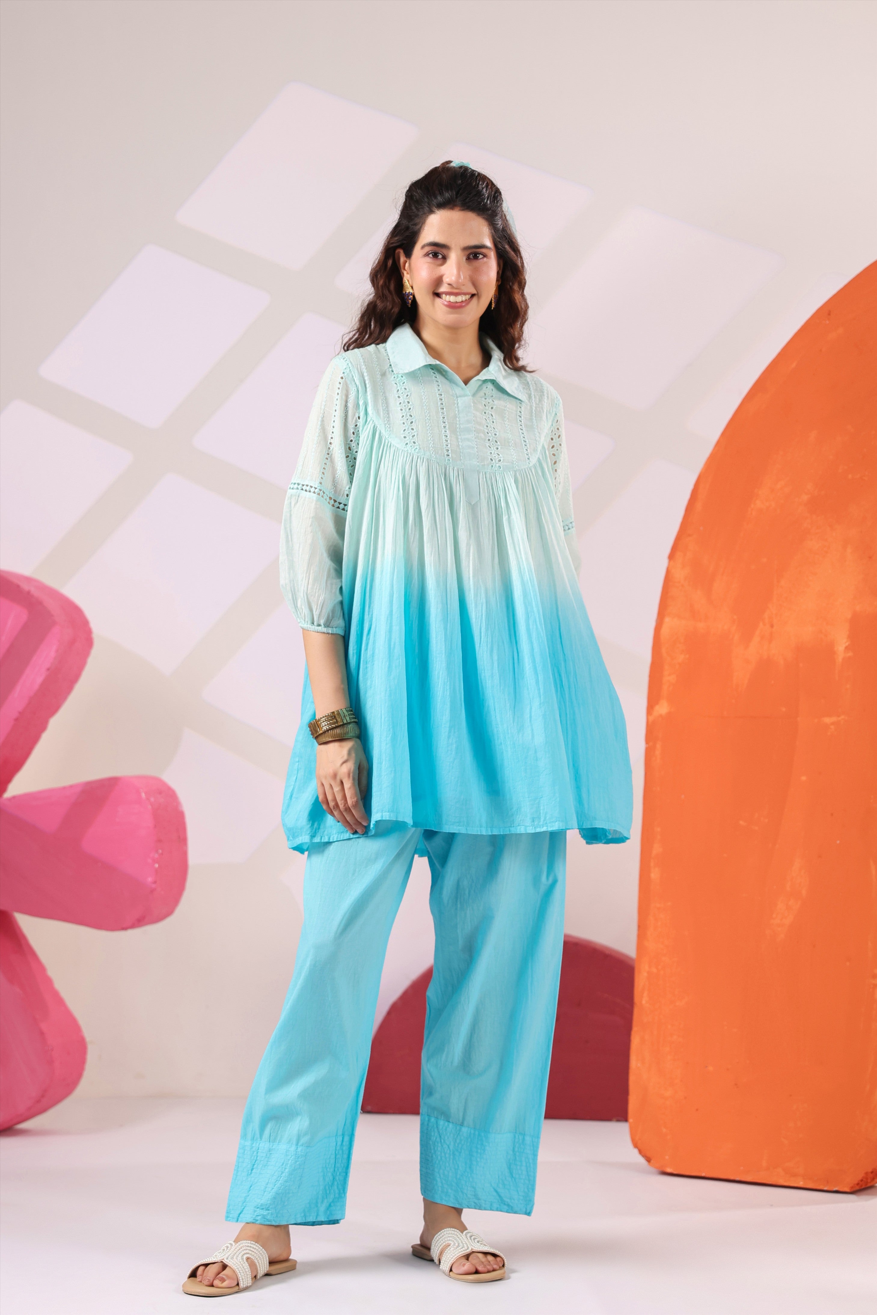 Woman wearing a premium sky blue ombre cotton co-ord set featuring a relaxed-fit tunic with lace detailing, shirt collar, three-quarter sleeves, and matching straight-fit pants, perfect for casual and summer wear.