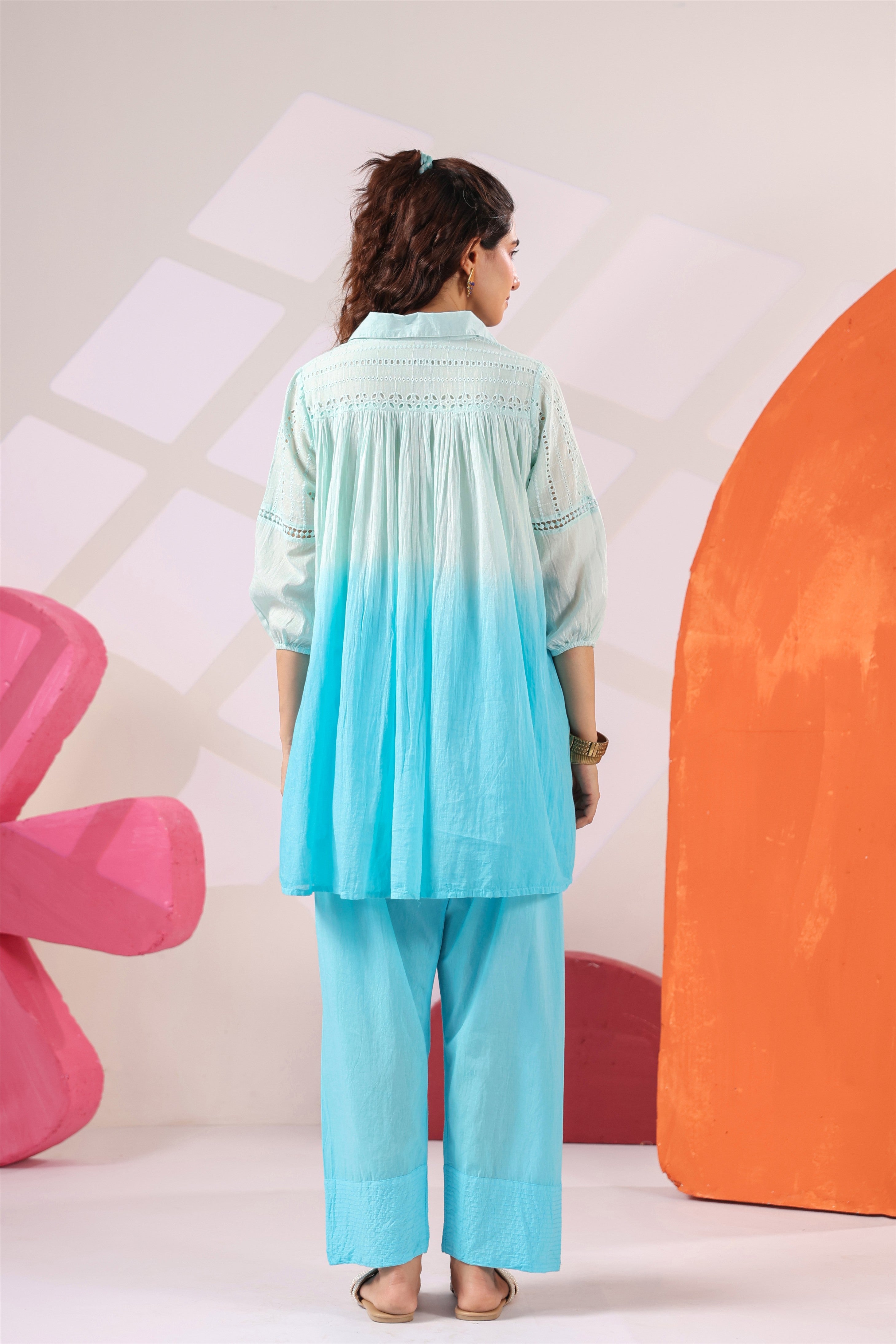 Woman wearing a premium sky blue ombre cotton co-ord set featuring a relaxed-fit tunic with lace detailing, shirt collar, three-quarter sleeves, and matching straight-fit pants, perfect for casual and summer wear.
