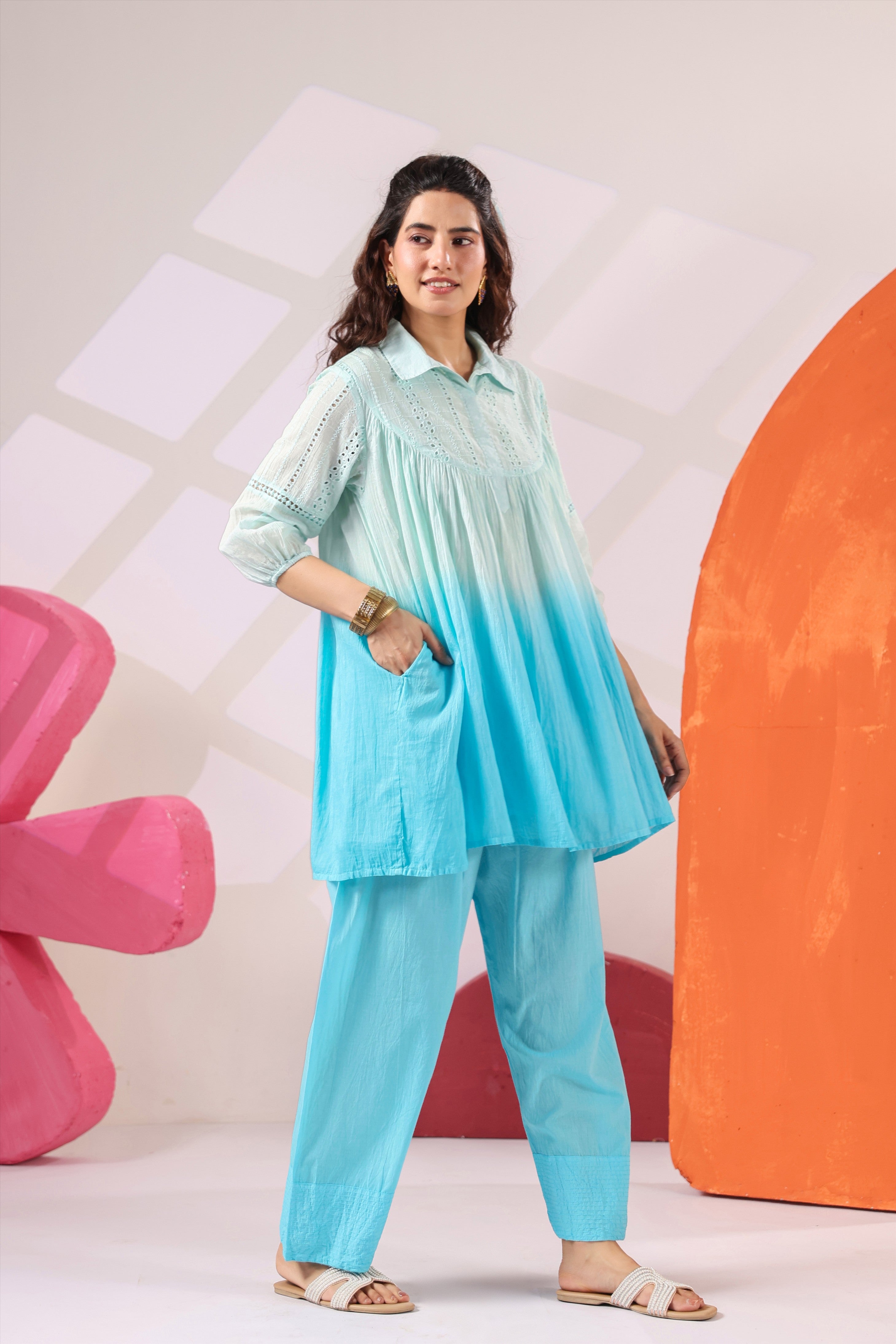 Woman wearing a premium sky blue ombre cotton co-ord set featuring a relaxed-fit tunic with lace detailing, shirt collar, three-quarter sleeves, and matching straight-fit pants, perfect for casual and summer wear.
