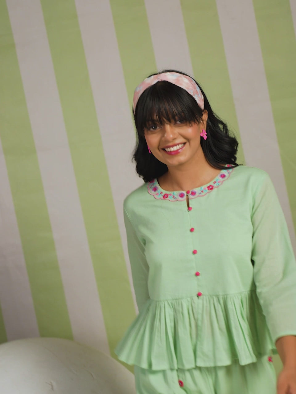 Woman wearing a pista green embroidered peplum co-ord set with wide-leg palazzo pants, round embroidered neckline, and floral detailing for ethnic casual wear