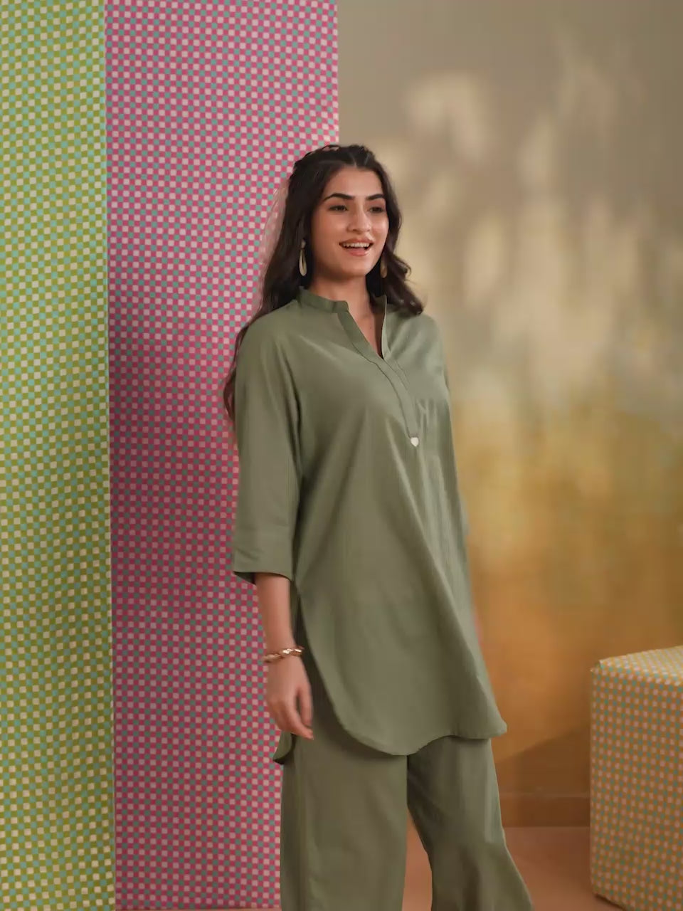 Woman wearing a sage green cotton co-ord set featuring a relaxed-fit straight kurta with a mandarin V-neck and matching elasticated jogger pants, ideal for casual, office, and everyday wear.