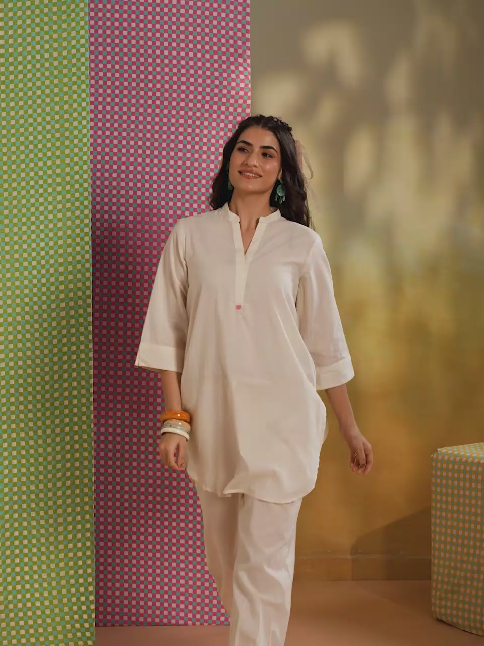 Woman wearing an ivory cotton co-ord set featuring a relaxed-fit straight kurta with a mandarin V-neck and matching elasticated jogger pants, offering a minimalist and elegant look for casual, office, and everyday wear.