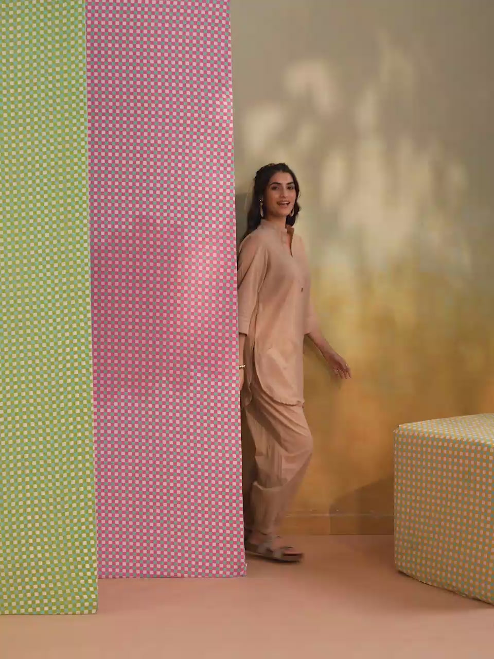 Woman wearing a beige cotton co-ord set featuring a relaxed-fit straight kurta with a mandarin V-neck and matching elasticated jogger pants, offering a minimalist and elegant look for casual, office, travel, and everyday wear.